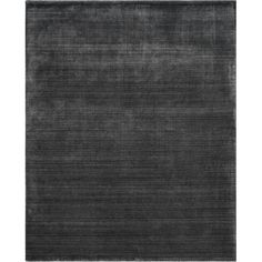 the rug is made from dark grey wool and has an uneven pattern on top of it