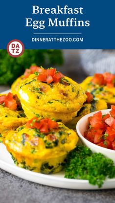 breakfast egg muffins on a plate with tomatoes and parsley in the background