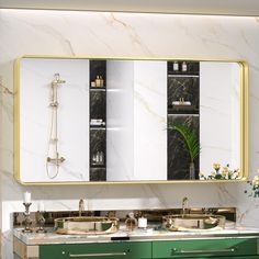 a bathroom vanity with two sinks and a large mirror above it that has gold trim