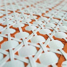 an orange and white tile pattern is shown in close up, as if it were made out of paper