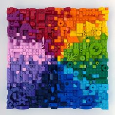 a multicolored piece of art made out of legos with letters and numbers