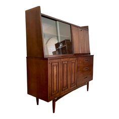 a wooden cabinet with glass doors and drawers