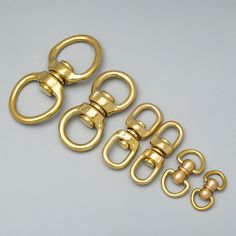 three pairs of gold - plated metal clasps