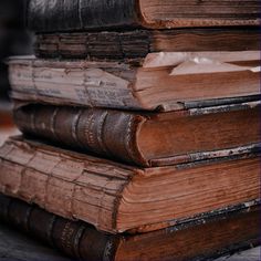 several old books stacked on top of each other