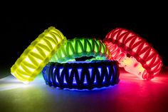 three glowing bracelets sitting on top of a table