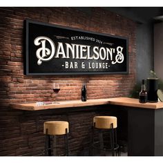 a bar and lounge sign hanging on the wall above two stools in front of it