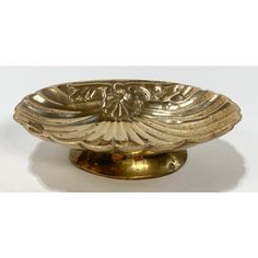 an ornate brass bowl on a white background