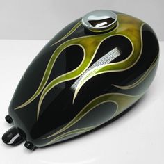 a black and green motorcycle helmet with flames on it