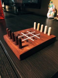 a wooden tic - tacquet sitting on top of a table