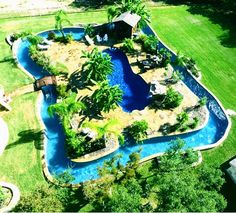 an aerial view of a pool surrounded by palm trees