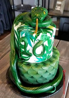 there is a green cake with a snake on it