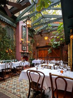 an indoor dining area with tables and chairs