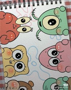 a spiral notebook with an image of four cartoon characters on it, all in different colors and sizes