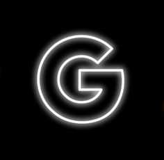 the letter g is lit up in white on a black background with an orange light