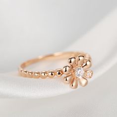 Hold the sweet memories of summer sun and fields of flowers with the rose gold "Charlotte" ring. 18k solid rose gold ring inspired by daisy flower, set with two CZs. Dimension: 0.33 inch wide Ring Thickness: 0.06 inch Weight: 1.7 grams Origin: Imported Fields Of Flowers, Gold Diamond Studs, Wide Ring, Flower Rose, Wide Rings, Cz Ring, Sweet Memories, Summer Jewelry, The Rose