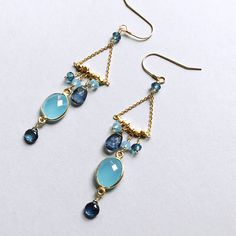 Our "chandies" are a modern take on classic chandelier earrings, using gemstone color combos and different stone shapes and sizes. - Bezel set blue chalcedony gemstones with iolite, blue chalcedony and london blue quartz- 3" long- French hooks- 14k gold plated .925 fine Italian sterling silver- Made in the USA in our NYC studio- Packaged in a gift box- Free shipping on US ordersHandmade to last. Our unique gold plating technique makes our jewelry tarnish resistant. The nature of natural gemstone Modern Blue Earrings With Gemstone Accents, Blue Gemstone Chandelier Earrings For Gifts, Blue Gemstone Chandelier Drop Earrings, Modern Blue Earrings With Natural Stones, Blue Chalcedony Dangle Jewelry, Chandelier Jewelry, Stone Shapes, Stones Earrings, Classic Chandelier