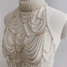 Add flair to your ensemble with the Sexy Beaded Pearl Body Chain Collar! This versatile piece doubles as a chest necklace or a sexy festival pearl top, perfect for white dress code parties, festivals, raves, or themed costume parties like Great Gatsby or Marie Antoinette. Crafted with pearls and beads, it exudes sophistication and style. Elevate your look and turn heads with this must-have accessory Pearl Body Chain, Chain Bra, Teeth Jewelry, Body Chains, Jewelry Pearl, Beaded Collar, Creation Couture, Waist Chain, Beaded Top