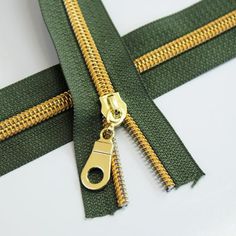 green and gold zippers on white background