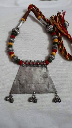 Vintage 1980s Handmade Rare Real Old High grade 80% Sterling silver Rajasthan Tribal banjara Artisan Pendant 26 inches longer adjustable New Cotton Multi Color Threaded Necklace Made By someone else. Discovered and collected by me. Primary Color of Pendant is vintage Silver, Pre- Owned Old looks. Weight of Necklace is 70 gms. Length of Pendant is 9 cm.with loop and dangles. Width of Pendant is 9.6 cm. It's a totally handmade Real old rajasthan tribal Necklace Bohemian Handmade Silver Temple Necklace, Handmade Bohemian Silver Temple Necklace, Bohemian Oxidized Necklace For Puja, Traditional Silver Necklaces With Latkans, Silver Necklaces For Ceremonial Navratri, Traditional Metal Necklaces With Silver Beads, Bohemian Necklace For Navratri Puja, Vintage Silver Jewelry For Festival, Traditional Metal Temple Necklace With Latkans