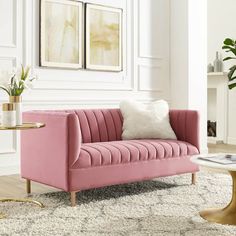 a living room with a pink couch and coffee table