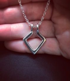 "Geometric Ring Holder Necklace, Sterling Silver, can choose an 18\", 20\" or 24\" sterling silver chain. Is a two-in-one necklace; one side is textured, the other side is smooth. A great way to wear rings when you can't have them on your hands. Ring necklace holders are also a meaningful way to wear the ring of someone dear to you. The Geometric Ring Holder pendant is approx. 22mm x 29mm or 7/8\" x 1 1/8\" (rings not included). It is one solid piece; no open ends nor soldered points. As with ha Sterling Silver Jewelry With Unique Design For Anniversary, Modern Diamond-shaped Jewelry For Wedding, Modern Diamond-shaped Wedding Jewelry, Minimalist Jewelry With Unique Design As Gift, Minimalist Sterling Silver Jewelry With Unique Design, Silver Jewelry With Unique Design For Gift, Unique Design Silver Jewelry For Gifts, Minimalist Diamond-shaped Jewelry For Wedding, Sterling Silver Simple Design Jewelry Gift