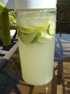 a tall glass filled with lemonade and lime