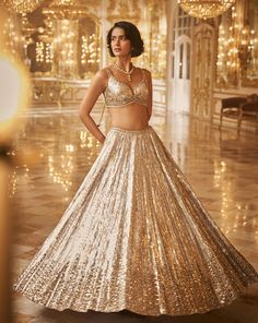 This lehenga set features intricate silver and gold crystal and sequin embroidery. The blouse shows crystal tassels at the waist. Embroidered dupatta also shows crystal tassels on all four sides. This outfit can also be styled with an organza blouse. Please note: The blouse style may slightly vary. Please reach out if you have any questions prior to purchasing.DELIVERY TIMEPlease allow 1 week for your outfit to arrive. FABRIC DETAILSNet Professional cleaning only. Crystal Lehenga, Garba Choli, Ivory Lehenga, Golden Lehenga, Seema Gujral, Lehenga Bridesmaid, Desi Outfits, Organza Shirt, Dresses Traditional