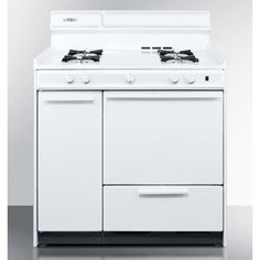 a white stove top oven sitting on top of a metal counter next to a wall