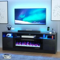 an entertainment center with a television and fire place in front of the tv on it