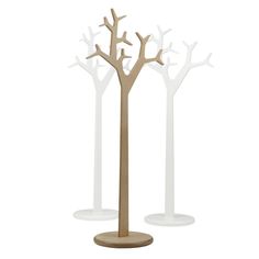 three white and wood trees on pedestals with one tree standing in front of the other