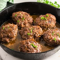 some meatballs are cooking in a skillet on the stove and ready to be eaten