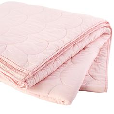 a pink quilted blanket folded on top of each other