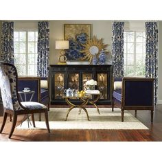 a living room filled with furniture and blue curtains