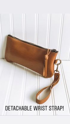 "This wristlet is the perfect for size for carrying your phone, cash, credit cards and lipstick. Made with distressed saddle tan leather. The inside is unlined natural suede. Bag closes with a zipper and leather pull. This bag has antique brass color hardware. Measures approximately 9 1/4\" wide, 5 1/4\" tall, and has a removable strap **Please note - this bag is made when ordered, please allow approximately 1 1/2 - 2 weeks production time. If you need something sooner, please contact me BEFORE Coin Purse Clutch With Wrist Strap, Daily Use Clutch Wristlet With Removable Pouch, Travel Wristlet Clutch With Mobile Phone Bag, Wristlet Pouch For Mobile Phone, Travel Clutch Wristlet With Mobile Phone Bag, Mobile Phone Bag Wristlet Pouch, Everyday Clutch Bag With Wrist Strap, Everyday Handheld Pouch With Wrist Strap, Casual Clutch Bag With Wrist Strap