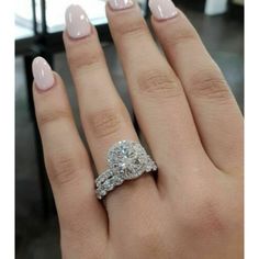 a woman's hand with a diamond ring on it