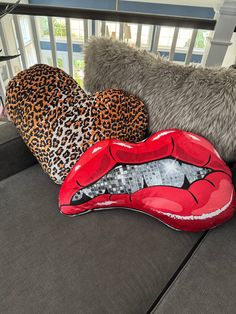 the pillows are shaped like lips and leopard print