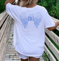 Big Little Shirts Sorority Reveal Big And Little Shirts Sorority Big/Little Reveal Shirts Big Little Reveal Little Big Gbig Shirts Big/Little Shirts Big Little Sorority Big Little Reveal Shirts Bigs And Little Shirts Retro big Little Angel Big Little QUICK  FACTS oGildan 5000 o100% preshrunk cotton. Unisex Heavy Cotton Tee oClassic fit. oTurn garment inside out. Wash and dry normally (on cool for best results). Do not dry clean. Do not iron. oActual product color may vary slightly from the listi Cotton Sorority Top With Text Print, White Relaxed Fit Shirt For School Spirit, Sorority Graphic Print Tops For College, White Short Sleeve Sorority Top, White Sorority T-shirt With Letter Print, White Crew Neck Sorority T-shirt, Sorority Cotton T-shirt With Graphic Print, White Sorority Graphic Print T-shirt, Sorority Relaxed Fit Graphic Print Tops