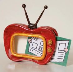 a red apple shaped like a television set