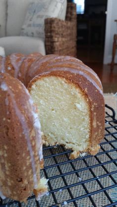 a bundt cake is on a cooling rack with one slice cut out and ready to be eaten