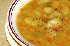 a white bowl filled with soup on top of a table