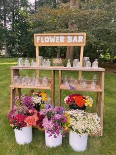 flower bar with flowers in buckets and mason jars on display for guests to see