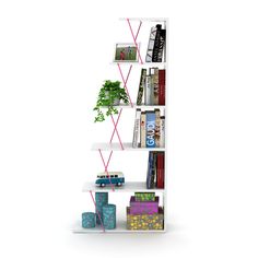 a white book shelf filled with books next to a potted plant on top of it