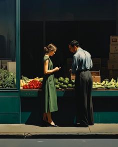 a man and woman standing in front of a fruit stand