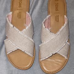 Light Taupe With Shimmer In Fabric. Slip On. Like Brand New. Worn Only Once, Inside Only. No Scuffs Or Wear And Tear. Size 7.5 Fringe Style Edge. Casual Tan Synthetic Sandals, Casual Open Toe Tan Sandals, Casual Tan Open Toe Sandals, Casual Tan Sandals For Spring, Casual Tan Flat Heel Sandals, Neutral Open Toe Casual Sandals, Casual Tan Flat Sandals, Fringe Fashion, Toms Shoes