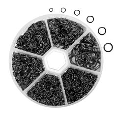 an assortment of black and white rubber bands in a circular container with two o - rings