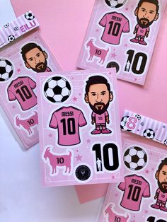 three pink stickers depicting soccer players and their name on them, including one with a beard