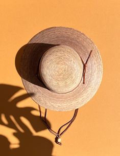 A sustainable and practical essential for warm sunny days, the Nelly hat is handmade from ethically grown palm leaves. With a sturdy brim and an open lattice design circling the top (allowing for ventilation during those humid summer months), this sun hat is the perfect finishing touch with jeans and a tee or pair it with your favorite sundress for a day in the park. Hand woven palm Fair Trade 100% natural palm leaf, grown in Mexico UPF50+ Water resistant Approx 3 1/2" brim Grosgrain inner band Artisan Handwoven Summer Straw Hat, Artisan Panama Hat For Beach In Spring, Artisan Panama Hat For Spring Beach, Bohemian Palm Leaf Boater Hat With Short Brim, Adjustable Artisan Sun Hat For Spring, Adjustable Wide Brim Panama Hat In Palm Leaf, Adjustable Flat Brim Palm Leaf Hat, Bohemian Short Brim Boater Hat, Artisan Woven Straw Hat For Summer