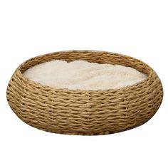 a round dog bed made out of wicker with a white blanket on the bottom