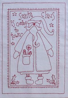 a cross - stitch christmas card with santa claus