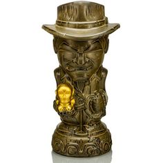 a golden statue with a hat on it's head and a skull in the middle